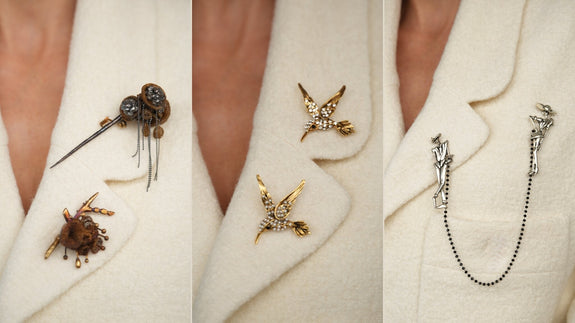 Mixed metal brooches styled together on a blazer